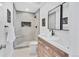 Modern bathroom featuring a walk-in shower and double vanity with contemporary fixtures at 2701 Barnhart St, Thornton, CO 80229