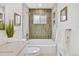 Serene bathroom with a bathtub and tiled walls, offering a peaceful space to unwind at 2701 Barnhart St, Thornton, CO 80229
