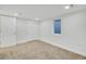 Bedroom with carpet flooring, a window, white walls, and closet with sliding doors at 2701 Barnhart St, Thornton, CO 80229