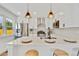 Modern kitchen featuring stainless steel appliances, white cabinets, and a quartz countertop island with bar seating at 2701 Barnhart St, Thornton, CO 80229