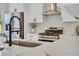 Modern kitchen with stainless appliances, a stylish faucet, and a functional range hood at 2701 Barnhart St, Thornton, CO 80229