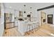 Beautiful kitchen with white cabinets and island, stainless steel appliances, and modern pendant lighting at 2701 Barnhart St, Thornton, CO 80229