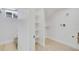 Bright laundry room features built-in shelving, tile flooring, and ample space at 2701 Barnhart St, Thornton, CO 80229