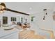 Open-concept living area with hardwood floors, a dining space, and seamless flow from the kitchen at 2701 Barnhart St, Thornton, CO 80229