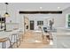 Open concept living space showcasing hardwood floors, a fireplace, and seamlessly connecting to the kitchen at 2701 Barnhart St, Thornton, CO 80229