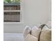 Bright living room with plush pillows, neutral colors, and natural light from the window at 2701 Barnhart St, Thornton, CO 80229