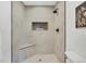 Elegant walk-in shower with sleek tile and a built-in shower niche for storage at 2701 Barnhart St, Thornton, CO 80229