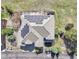 Aerial shot highlighting solar panels on the roof of the home with a paved driveway and mature trees at 791 Elk Rest Rd, Evergreen, CO 80439