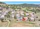 This aerial shot showcases the house, nestled into the hillside, with great outdoor entertaining spaces at 791 Elk Rest Rd, Evergreen, CO 80439
