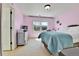This bedroom features light pink walls, a large window, and light-colored carpet at 791 Elk Rest Rd, Evergreen, CO 80439