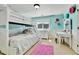 This bedroom features a bunk bed, a white dresser, and white wainscoting and trim at 791 Elk Rest Rd, Evergreen, CO 80439