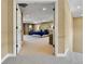 View of a spacious bedroom with carpeting, a tray ceiling, and a large bed with a tufted headboard at 791 Elk Rest Rd, Evergreen, CO 80439