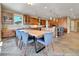 A large open kitchen and eat in area includes stainless appliances, wooden cabinets, and a large island at 791 Elk Rest Rd, Evergreen, CO 80439