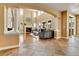 Elegant living room featuring a fireplace, soaring ceilings, large windows, and luxury flooring at 791 Elk Rest Rd, Evergreen, CO 80439