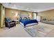 Spacious main bedroom featuring a large bed, sitting area, soft carpet, and recessed lighting at 791 Elk Rest Rd, Evergreen, CO 80439
