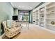 A well-appointed home office with built-in shelving, a desk, and a comfortable chair at 791 Elk Rest Rd, Evergreen, CO 80439