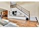 A grand staircase ascends next to a custom built-in entertainment center with white cabinetry at 791 Elk Rest Rd, Evergreen, CO 80439