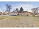 Backyard view showing a large grassy area and home exterior at 1338 Aspen Pl, Longmont, CO 80501