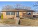 Brick ranch home with a ramp and a well-maintained lawn at 1338 Aspen Pl, Longmont, CO 80501