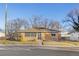 House's front yard with mature trees and a paved driveway at 1338 Aspen Pl, Longmont, CO 80501