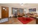 Bright living room featuring hardwood floors and comfortable leather seating at 1338 Aspen Pl, Longmont, CO 80501