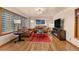 Living room with hardwood floors, a fireplace, and a view of the kitchen at 1338 Aspen Pl, Longmont, CO 80501