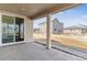 Covered back patio with sliding glass door offers a lovely view of the backyard and neighborhood at 25041 E 38Th Ave, Aurora, CO 80019