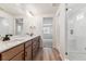 Bright bathroom featuring double sink vanity with granite countertops and glass shower at 25041 E 38Th Ave, Aurora, CO 80019