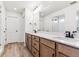 Modern bathroom with wood vanity, dual sinks, quartz countertop, and glass shower at 25041 E 38Th Ave, Aurora, CO 80019