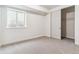 This bedroom features neutral carpet, a closet, and a window letting in natural light at 25041 E 38Th Ave, Aurora, CO 80019