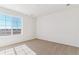 Cozy bedroom featuring carpeted floors and a large window at 25041 E 38Th Ave, Aurora, CO 80019