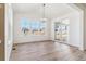 Bright dining room featuring luxury vinyl plank flooring, modern chandelier and backyard access at 25041 E 38Th Ave, Aurora, CO 80019