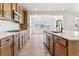 Open kitchen features stainless steel appliances, an island with a sink and pendant lighting at 25041 E 38Th Ave, Aurora, CO 80019