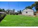Expansive backyard featuring an oversized detached garage and well-maintained lawn perfect for outdoor activities and storage at 3999 W Chenango Ave, Littleton, CO 80123
