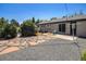 Outdoor patio, rock garden, and grassy areas offer different zones for relaxation and activities in this backyard at 3999 W Chenango Ave, Littleton, CO 80123