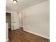 A modern bedroom with dark wood floors, white walls, and a double door closet provides style and functionality at 3999 W Chenango Ave, Littleton, CO 80123