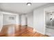 Bright bedroom featuring hardwood floors, neutral paint, a large window, closet space, and an en-suite bathroom at 3999 W Chenango Ave, Littleton, CO 80123