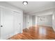 Bedroom featuring hardwood floors, neutral paint, large closet space, and two large windows at 3999 W Chenango Ave, Littleton, CO 80123