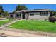 Charming single-story home with a well-manicured lawn and inviting entryway at 3999 W Chenango Ave, Littleton, CO 80123