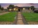 Inviting home exterior with a lush green lawn and a cozy, welcoming appearance at 3999 W Chenango Ave, Littleton, CO 80123