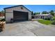 A detached garage and an expansive concrete driveway and a partial backyard view at 3999 W Chenango Ave, Littleton, CO 80123