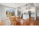 Cozy eat-in kitchen featuring stainless appliances, white cabinets, granite countertops, and sliding door access to backyard at 3999 W Chenango Ave, Littleton, CO 80123