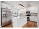 Beautiful kitchen with white cabinets, stainless appliances, granite countertops, hardwood floors, and ample counter space at 3999 W Chenango Ave, Littleton, CO 80123