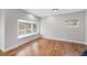 Bright living room featuring hardwood floors, large bay window, and neutral paint at 3999 W Chenango Ave, Littleton, CO 80123