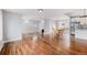 Large, open living area featuring hardwood floors, neutral paint, and a view of the eat-in kitchen and backyard at 3999 W Chenango Ave, Littleton, CO 80123