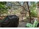 Backyard deck with gas BBQ, surrounded by trees and greenery at 12051 E Lake Cir, Greenwood Village, CO 80111