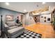 Open basement featuring hardwood floors, a staircase, a cozy seating area and a modern lamp at 12051 E Lake Cir, Greenwood Village, CO 80111