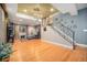 Open basement area featuring hardwood floors, a modern staircase, and a cozy seating area at 12051 E Lake Cir, Greenwood Village, CO 80111