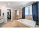 A bathroom with a soaking tub and a tiled shower with glass doors, plus a view to the closet at 12051 E Lake Cir, Greenwood Village, CO 80111