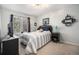 Cozy bedroom features a plush bed, mounted shelves and a large window allowing natural light at 12051 E Lake Cir, Greenwood Village, CO 80111